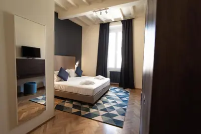a hotel room with a bed and a mirror at BEIGE ET BLE' GuestHouse in Rome