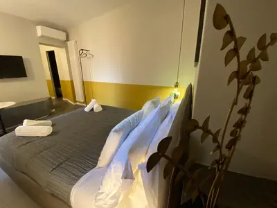 a bedroom with a bed with blue sheets at Cavour Urban Rooms by GHOR in Rome