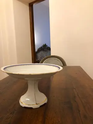 a table with a white plate on top of it at Visione Via Sant’Andrea delle Fratte, 36 in Rome