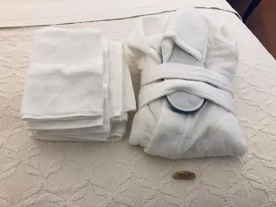 a pile of towels sitting on top of a bed at Visione Via Sant’Andrea delle Fratte, 36 in Rome