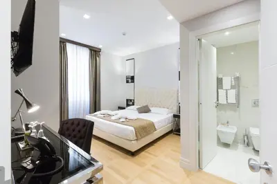 a hotel room with a bed and a bathroom at Floris Hotel in Rome