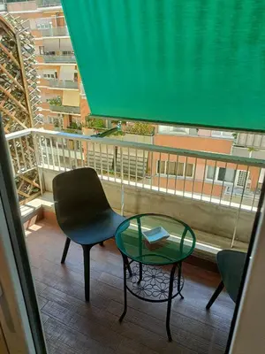 a balcony with a table and a chair and a window at Vatican Break Home in Rome