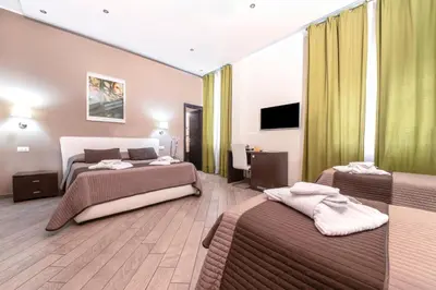 a hotel room with two beds and a flat screen tv at Mia Resort in Rome