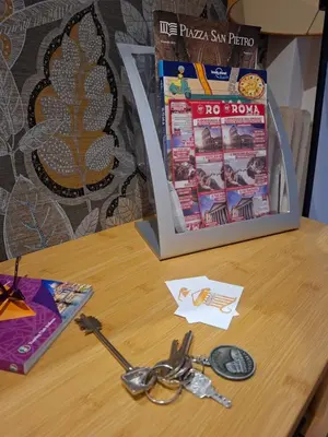 a table with a pair of scissors and a magazine at Athena's Apartment in Rome