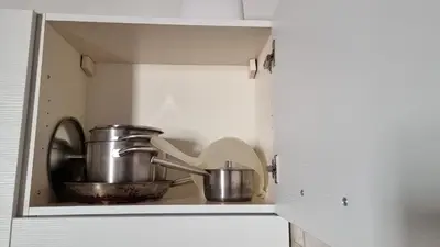 a cupboard with two pots and pans in it at Studio della Pace, Classy & Charming - RENOVATED in Rome