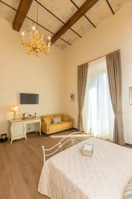 a bedroom with a bed and a couch and a chandelier at Kings Home In Rome in Rome