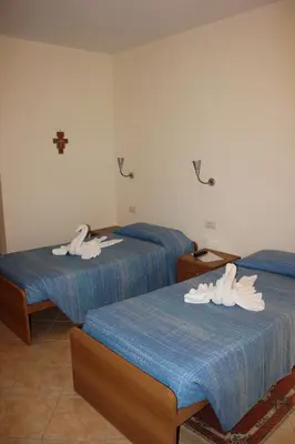 a room with two beds with white shoes on them at Casa per Ferie Beato Rosaz in Rome