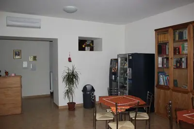 a room with a ping pong table and a refrigerator at Casa per Ferie Beato Rosaz in Rome