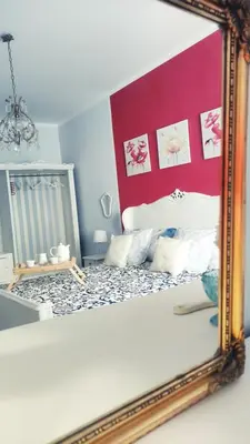 a mirror reflecting a bed in a room at Garbatella Chippendale Apartment in Rome