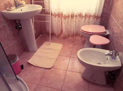 a bathroom with a toilet and a sink at Garbatella Chippendale Apartment in Rome