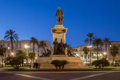 a statue in front of a building with palm trees at The Shell Rome Suite in Rome