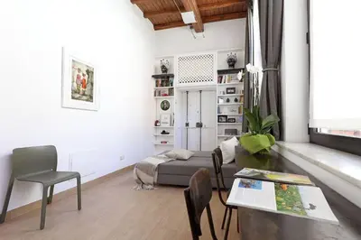 a living room with a table and a couch at Luxury House Colosseo in Rome