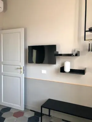 a room with a wall with a tv and a door at CORNER211 in Rome