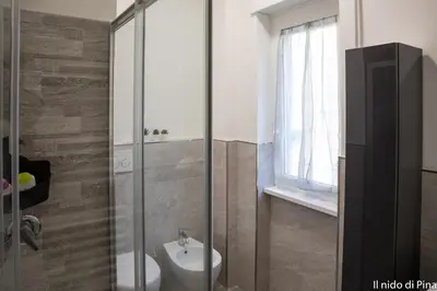 a bathroom with a shower and a sink and a toilet at Nido di Pina in Rome
