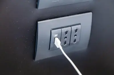 an electrical outlet with a wire plugged into it at Frattina High-end apt in Rome