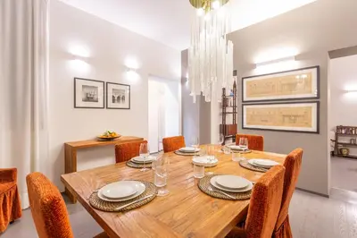 a dining room with a wooden table and chairs at Spanish Steps DeLuxe Apartment in Rome