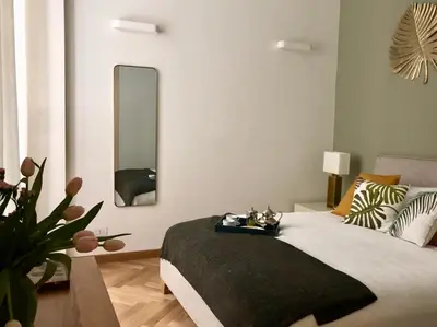 a bedroom with a bed and a large mirror at Opera Luxury Rosmini in Rome