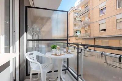 a balcony with a white table and two chairs at B&B Il Dogandiere in Rome