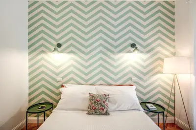 a bedroom with a chevron accent wall at Trastevere 2.0 in Rome