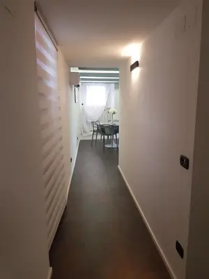 a hallway leading to a dining room with a table at Clementinam Suite Colosseum in Rome