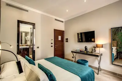 a hotel room with a bed and a television at Relais De La Poste in Rome