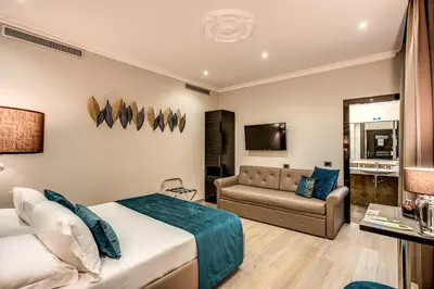 a hotel room with a bed and a couch at Relais De La Poste in Rome