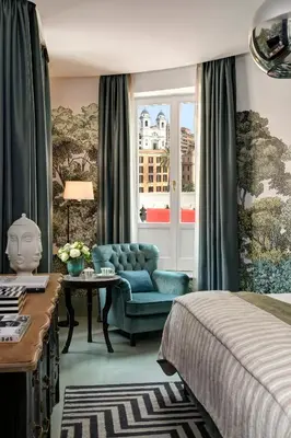 a bedroom with a bed and a chair and a window at Rocco Forte House Piazza Di Spagna, Rome in Rome