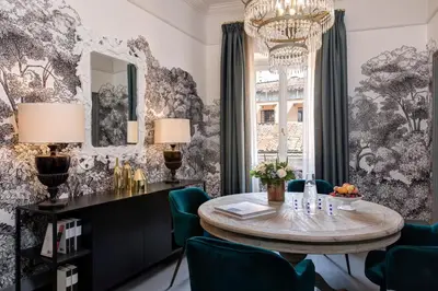 a dining room with a table and chairs and a chandelier at Rocco Forte House Piazza Di Spagna, Rome in Rome
