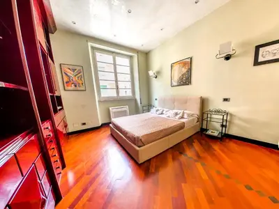 a bedroom with a bed and a large window at Charming apartment in San Giovanni 90m from Metro in Rome
