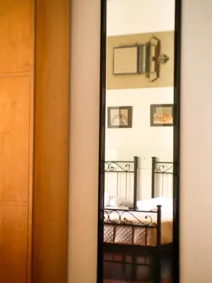 a mirror in a room with a bed at Charming apartment in San Giovanni 90m from Metro in Rome