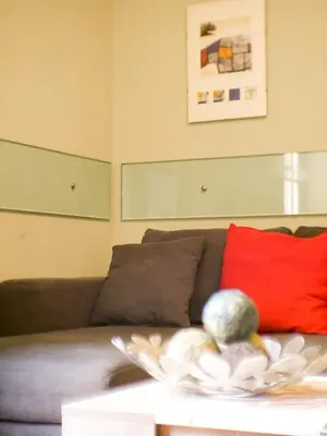 a living room with a couch and a red pillow at Charming apartment in San Giovanni 90m from Metro in Rome