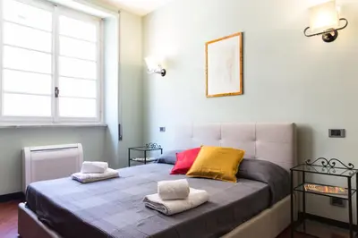 a bedroom with a large bed with two pillows on it at Charming apartment in San Giovanni 90m from Metro in Rome