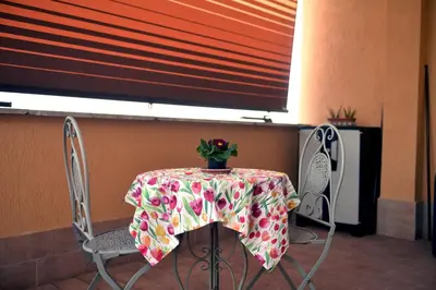 a table with a table cloth with a plant on it at In Terrazza Da Giusy in Rome