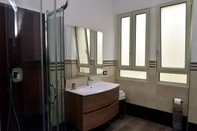 a bathroom with a sink and a glass shower at In Terrazza Da Giusy in Rome