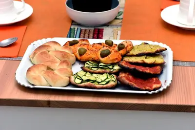 a plate of food with sausage and bread on a table at In Terrazza Da Giusy in Rome
