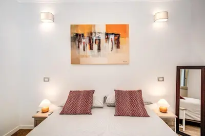 a bedroom with a white bed with two pillows at Novembre 152 Apartment in Rome