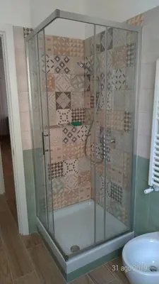 a shower with a glass enclosure in a bathroom at Casa di Rosita in Rome