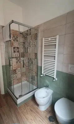 a bathroom with a shower and a toilet and a sink at Casa di Rosita in Rome