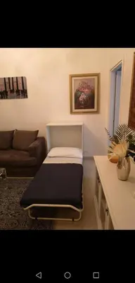a bed in a living room with a couch at Cathy's Luxury Home in Rome