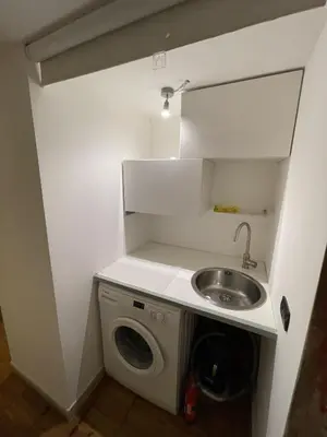 a kitchen with a sink and a washing machine at Heart of San Lorenzo - La casa particular in Rome