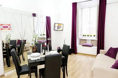 a living room with a table and a dining room at Fantasie in Trastevere in Rome