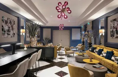 a hotel lobby with couches and tables and a chandelier at Leonardo Boutique Hotel Rome Monti in Rome