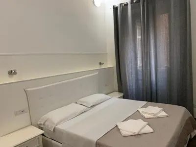a bedroom with a bed with two towels on it at Golden Nice in Rome