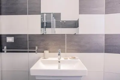 a bathroom with a white sink and a mirror at The Castle Inside Rome in Rome