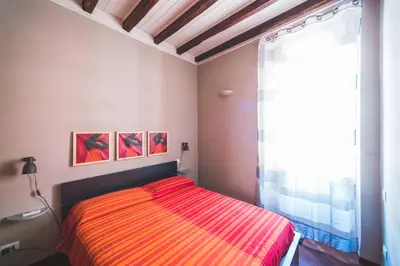 a bedroom with a bed and a large window at Colosseum nest in Rome