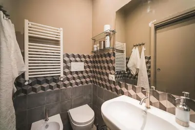 a bathroom with a toilet and a sink at Colosseum nest in Rome