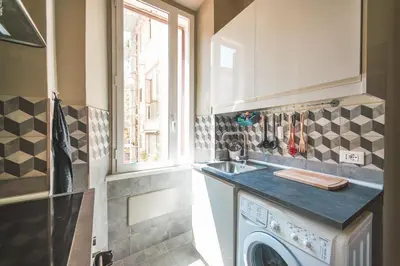 a kitchen with a sink and a washing machine at Colosseum nest in Rome