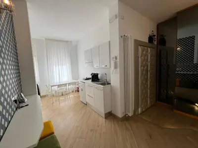 a kitchen with white cabinets and a white refrigerator at Affreschi al Vaticano in Rome