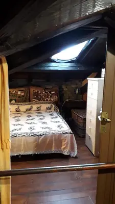 an attic room with a bed and a dresser at B&BGarbatella in Rome