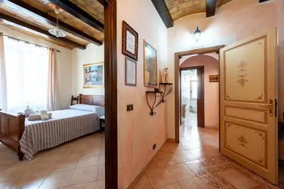 a bedroom with a bed and a large window at Kyterion Apartment in Rome